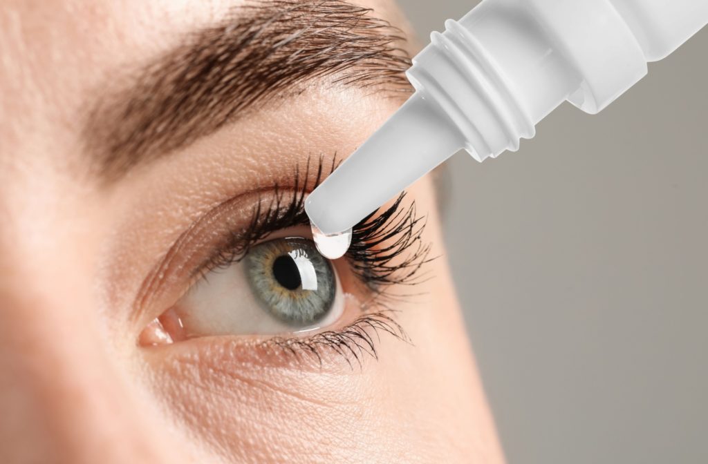 Close-up of an eye dropper about to apply hydrating eye drops to a person's eye.