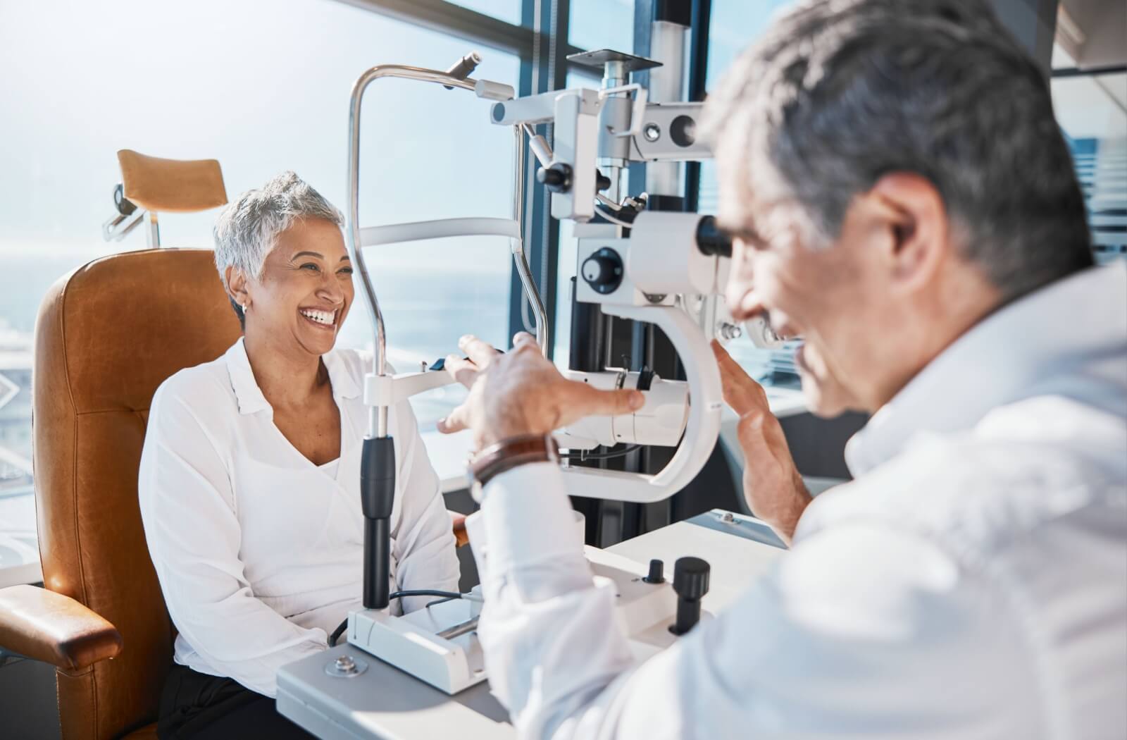 An optometrist assesses their patient's ocular health during a routine eye exam.