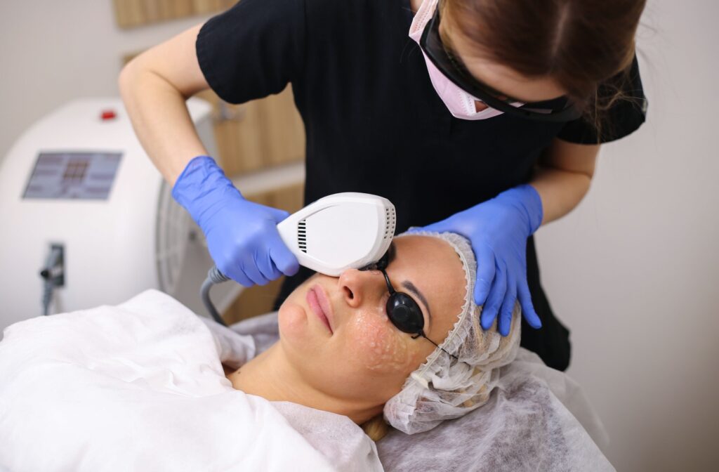 An eye doctor performs IPL therapy on their patient to help alleviate dry eye symptoms.